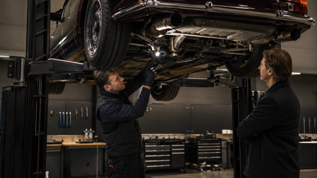 Collector car undergoing an independent pre-purchase inspection on a vehicle lift